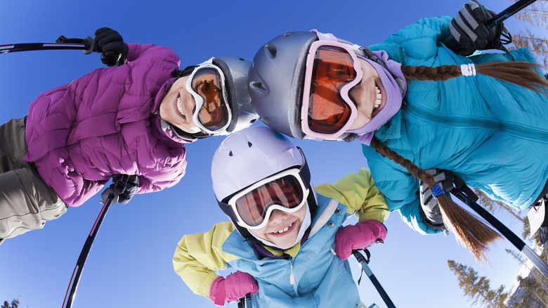 happy skiers family takes photo while out skiing in New York