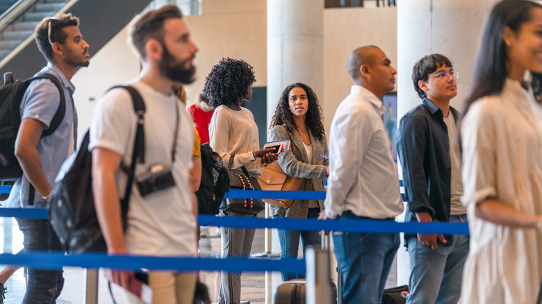 people waiting in airport line