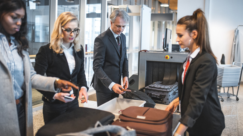 travelers at airport security checkpoint