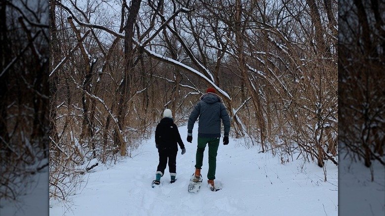 Two people walking in snow