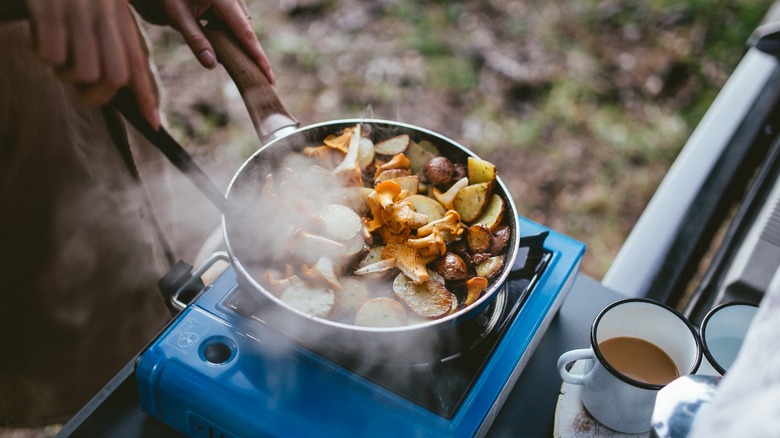 Person cooking on camping stove