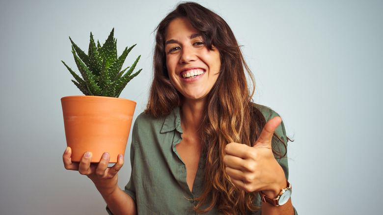 A woman holding a plant