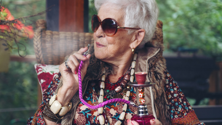 older woman holding hookah