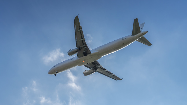 a plane in the sky shown from below