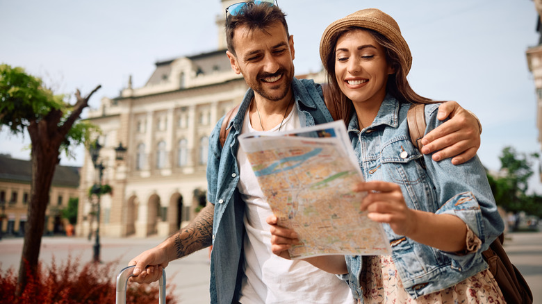 Traveling couple looking at a map