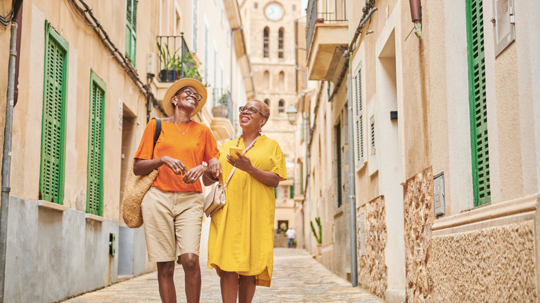 Travelers walking down European street