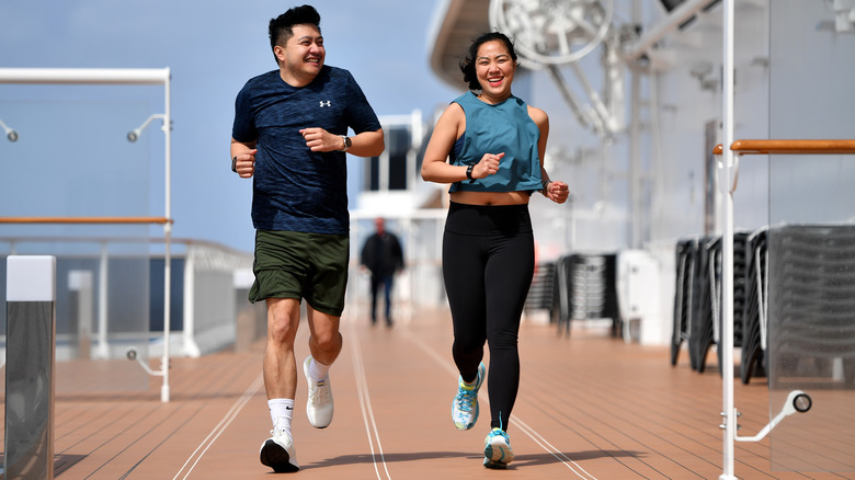 Couple jogs on cruise deck