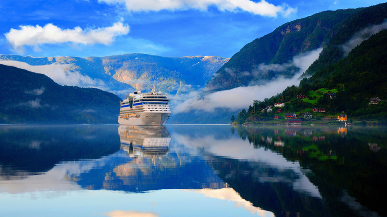 Cruise ship in still waters of fjord