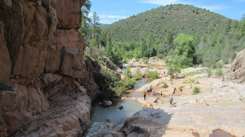 Hikers relax in watery ravine