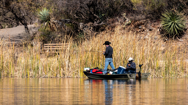 Two men fishing in lake