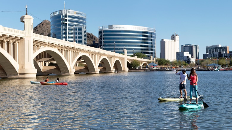 People on stand-up paddleboards and kayaks in Tempe Town Lake