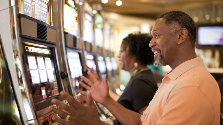 Man playing slot machines