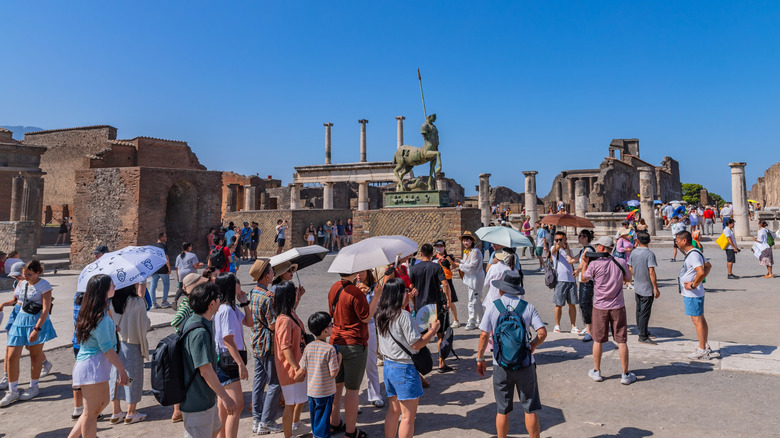 tourists around ancient buildings