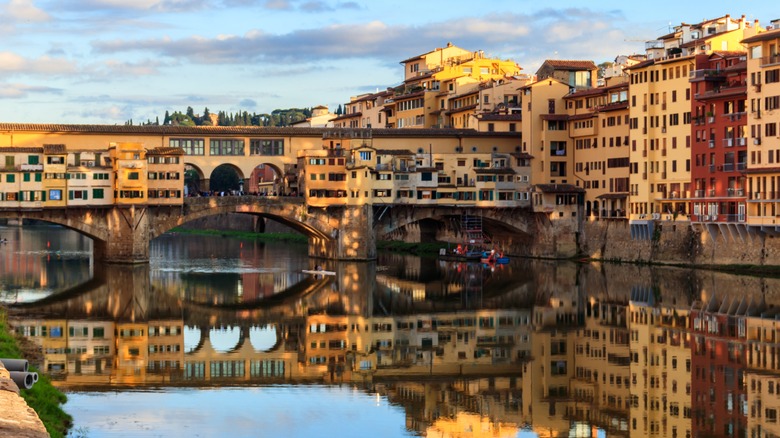 bridge reflected in water and buildings