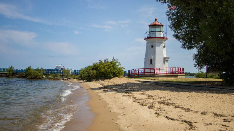 lighthouse, pier, and beach