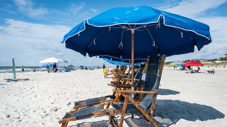 beach chairs with umbrella on white sand at Coligny Beach Park