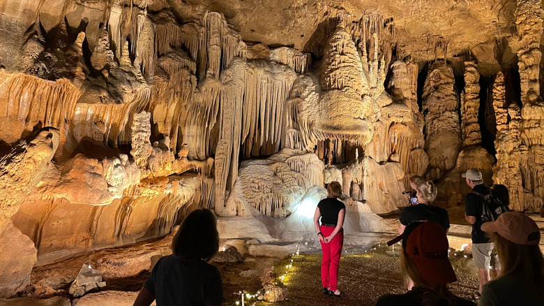 Visitors admire rock formations inside Cave Without a Name, Texas