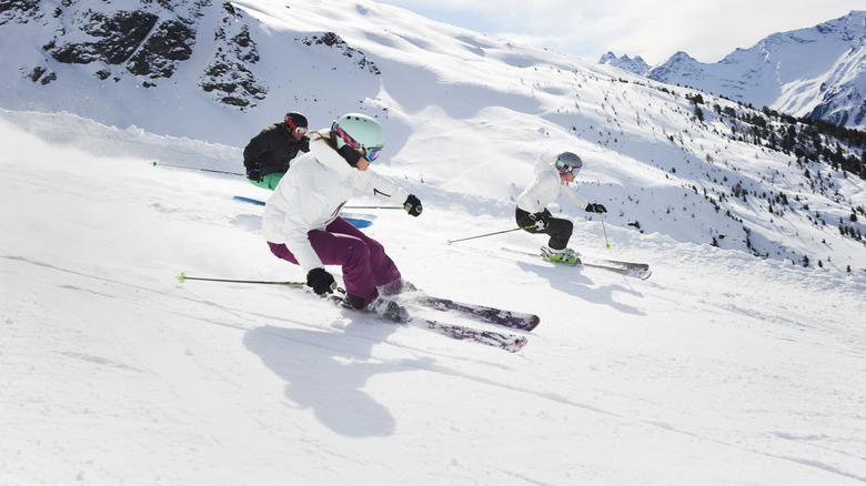 Three people skiing