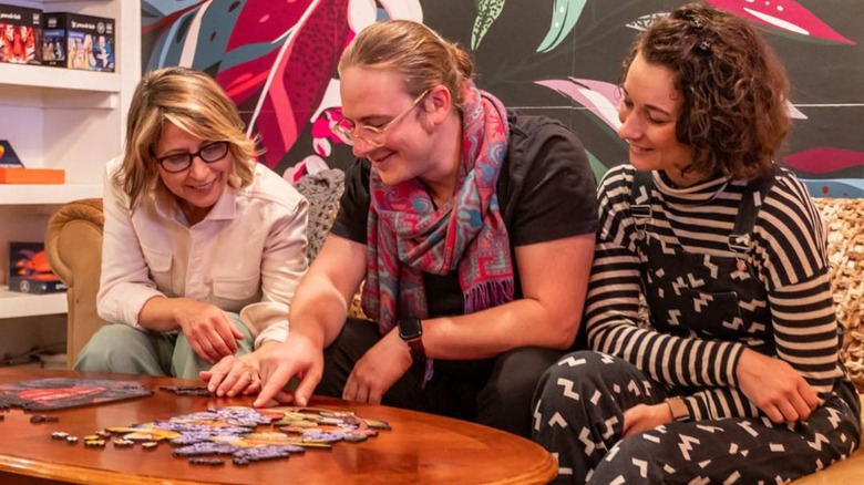 Samantha Brown with people doing puzzle