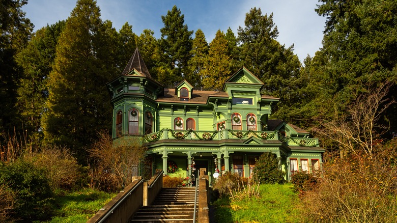 green mansion surrounded by trees