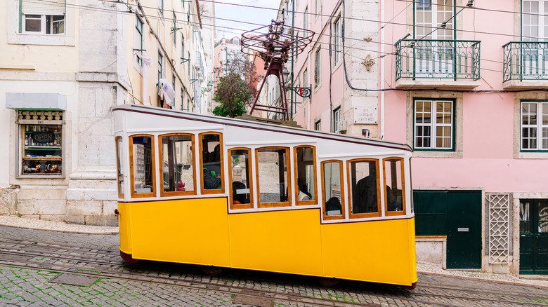 yellow tram on steep street in Lisbon