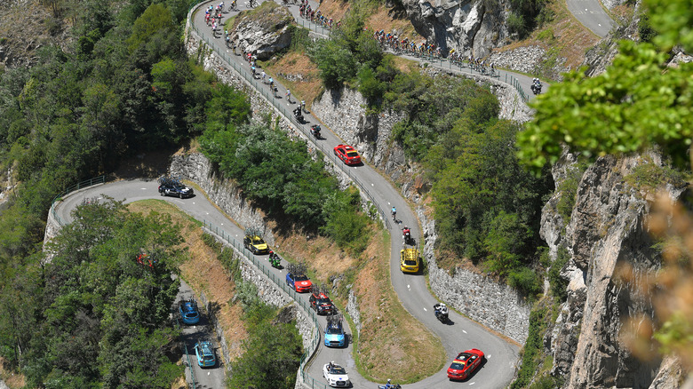 Cars and cyclists navigating hairpin turns