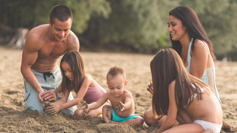 Family playing in sand