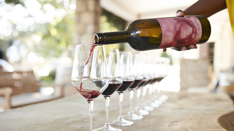 A woman pouring wine