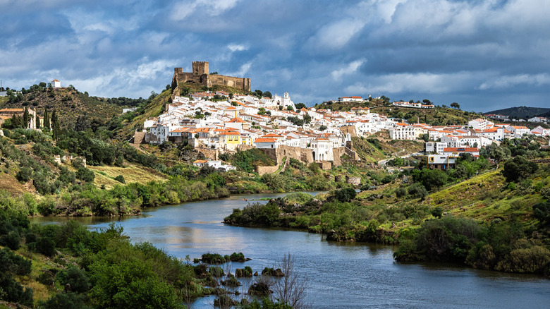 whitewashed hill town overlooking river