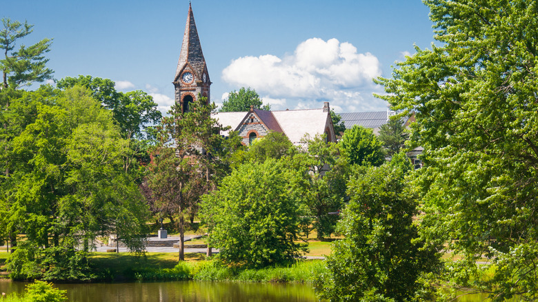 Church among trees by pond