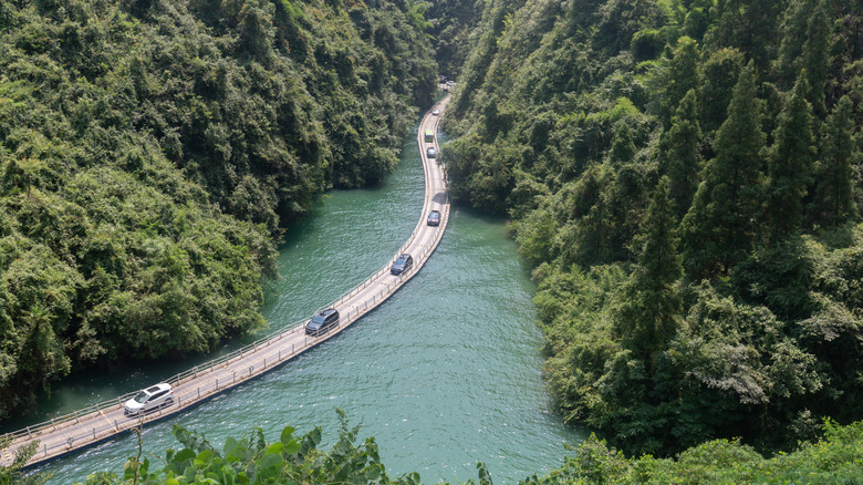 Cars driving over the Shiziguan Floating Bridge over the River Qingjiang in China's Enshi Prefecture.