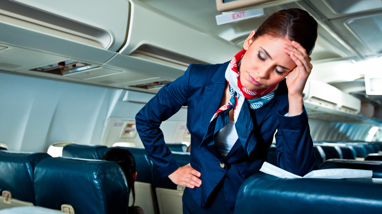 tired flight attendant on plane