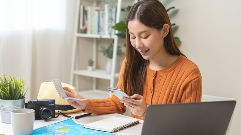 Traveler using computer before trip