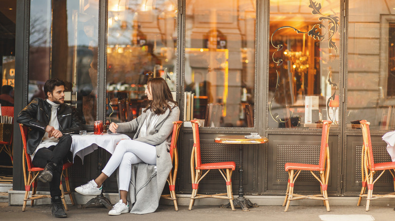 Couple sitting outside a café in Paris
