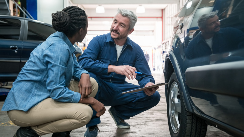 Person consulting a mechanic