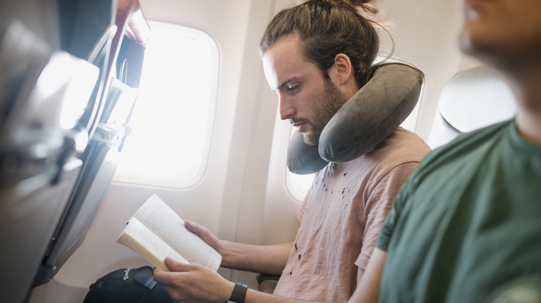 man reading on an airplane