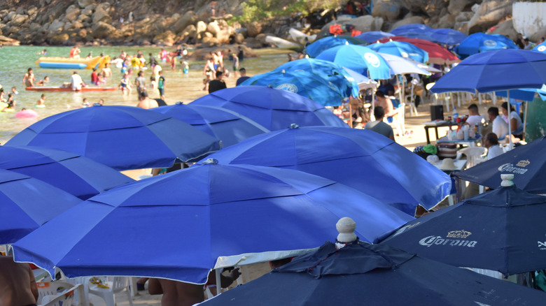 blue umbrellas along Playa Roqueta Mexico