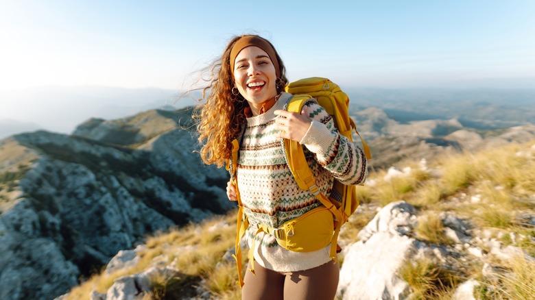 Smiling hiker in mountain landscape