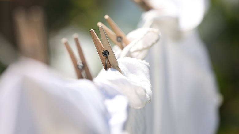 Close-up on clothespins holding linen