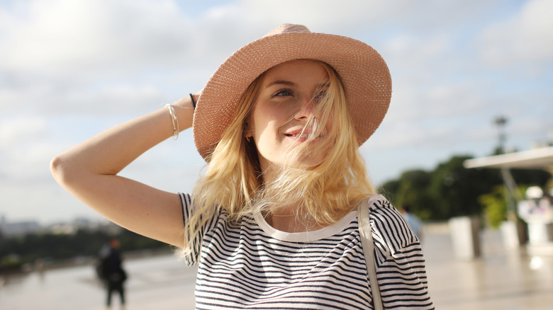 Traveler wearing wide brim hat