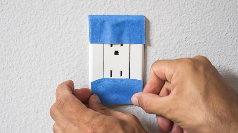Blue painter's tape covering outlet