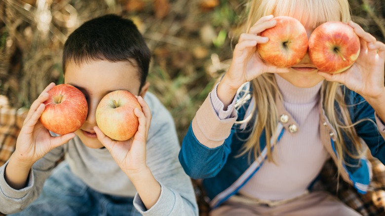 Children playing in apple orchard