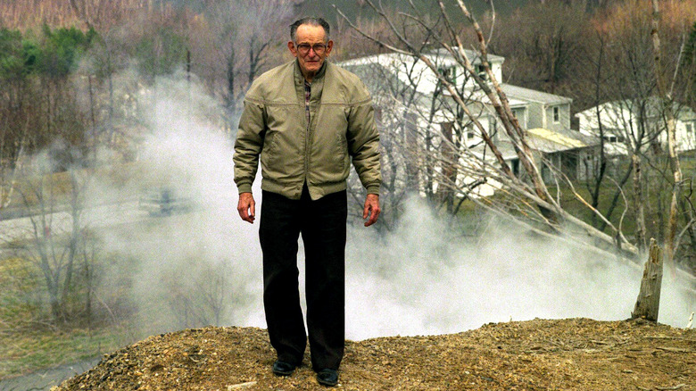 Man with smoke behind him