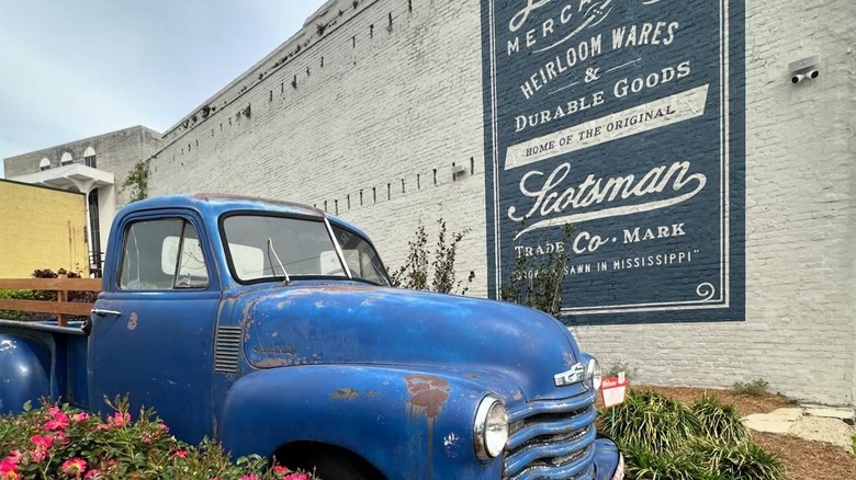 Old blue pickup with Laurel Mercantile sign