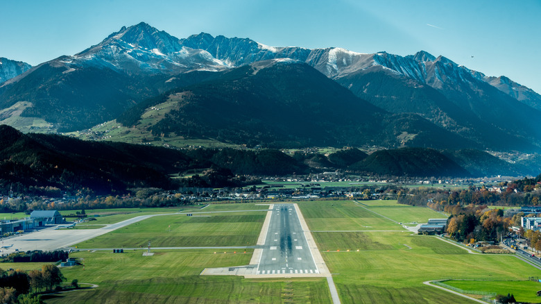 Airport landing strip with mountains in background