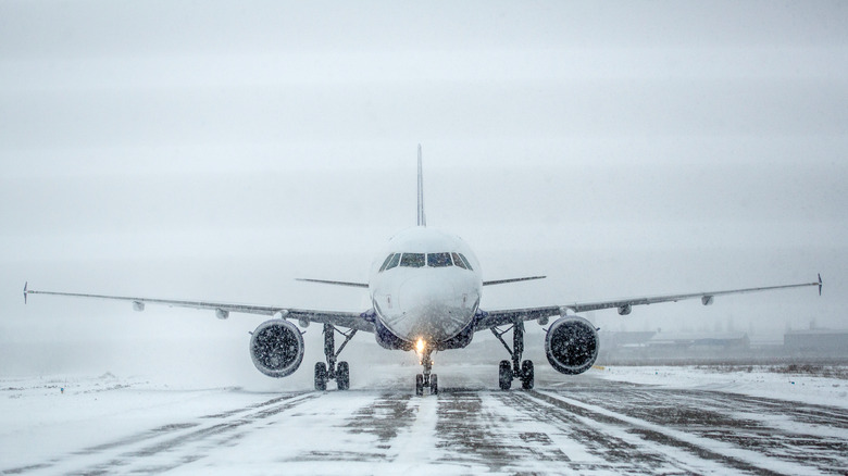 Airplane on runway in a blizzard