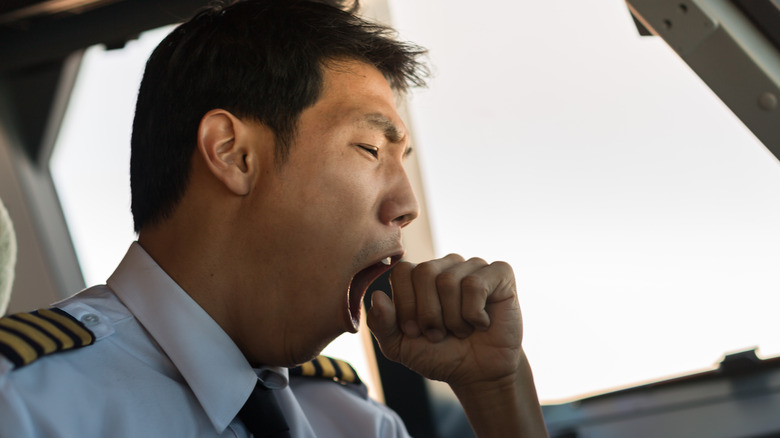 Yawning pilot on plane