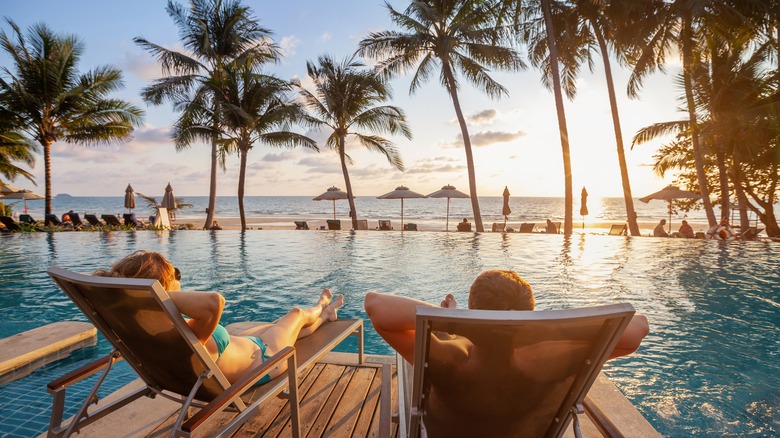 Couple lounging by pool