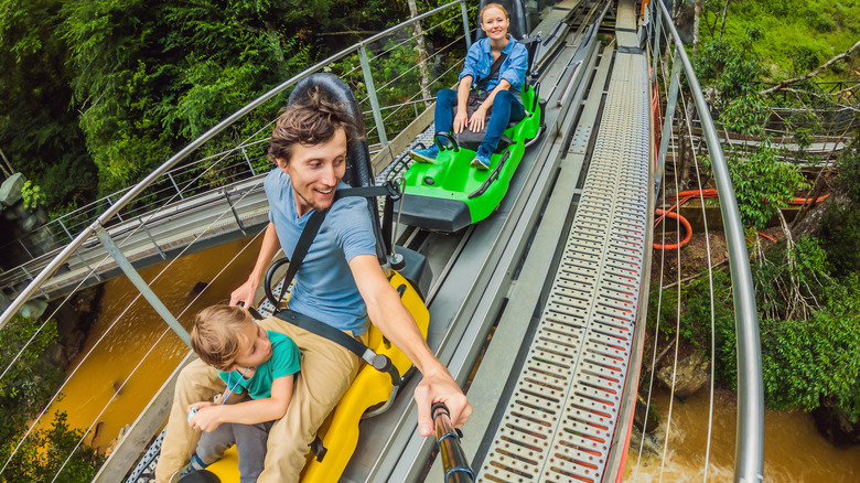 family riding mountain coaster