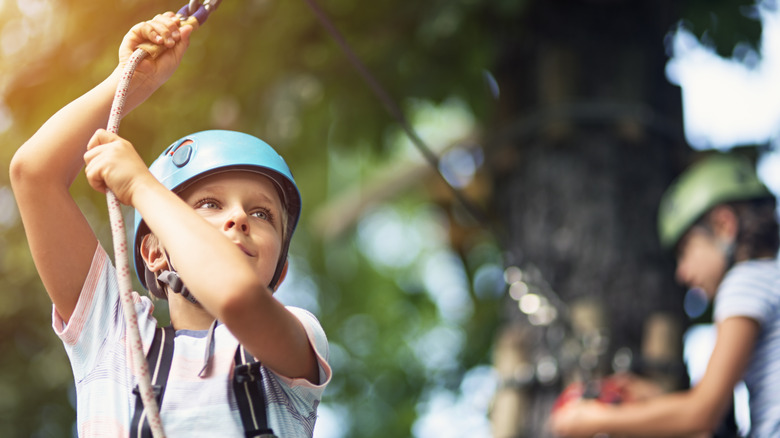 Young child on a zip line course